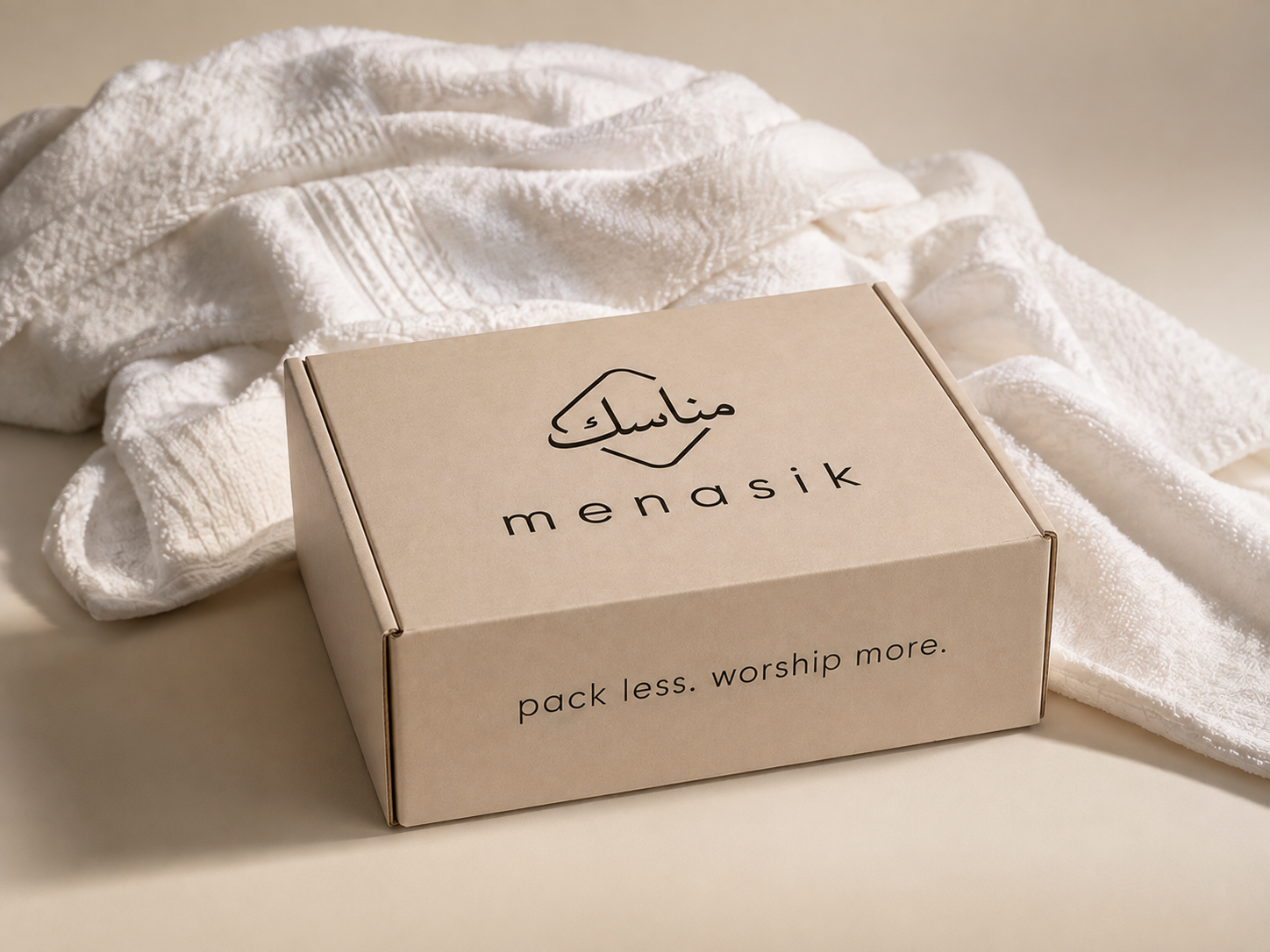 Menasik Kit With Ihram beside folded white ihram cloth